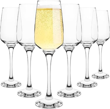 a row of wine glasses with champagne in front of a white background