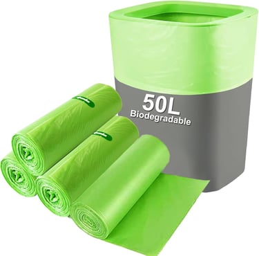 a green trash canister with a roll of garbage bags