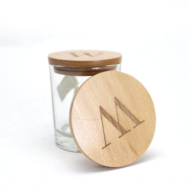 Personalized glass storage jar with custom engraved wooden lids featuring alphabet monograms.