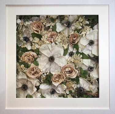 a white and peach flower wall style preserved wedding bouquet in a frame