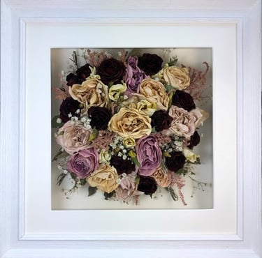 Birdseye view preserved wedding bouquet in a frame with deep reds and winter berries