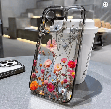 Clear iPhone case featuring a vibrant pressed floral garden design with colorful pink and orange wildflowers.