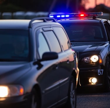 police car pulling over another car on the road