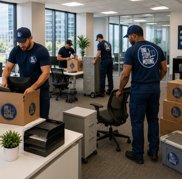 Professional movers in blue uniforms packing boxes and relocating office furniture in a modern corporate space.