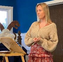 Woman standing at a wooden lectern