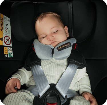 a baby in a car seat with a sleeping pillow sleepfix