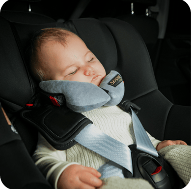 a baby in a car seat with a sleeping pillow sleepfix