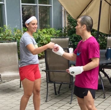 a man and woman holding hands and shaking hands after martial arts training outside