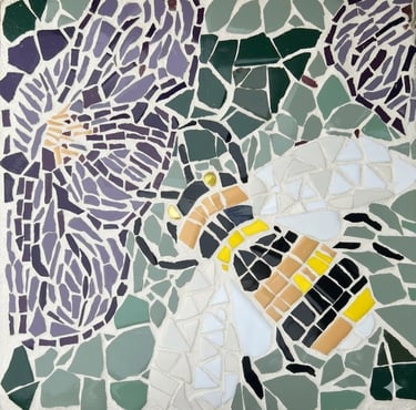 Hand-crafted garden stepping stone mosaic of a bee, violet flowers & leaves by artist Julie Curson