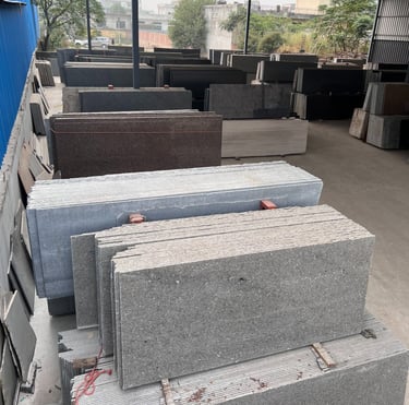 a pile of granite slabs in a gold stone granites mohali warehouse