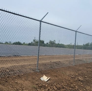Chain link security fencing with barbed wire