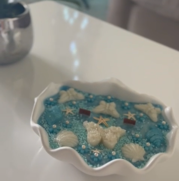 Exquisite decorative scented candle with blue hand poured wax, decorated with shells and butterflies