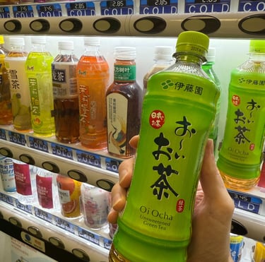 a person holding a bottle of green tea
