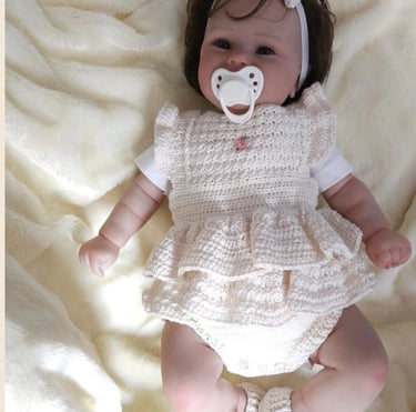 a baby girl wearing a white dress and pacifier pacifier pacifier pacifier