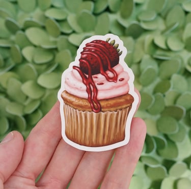 a person holding a sticker of a strawberry cupcake