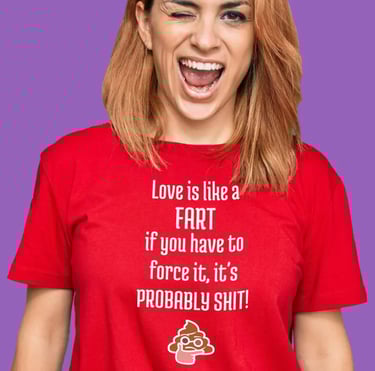 Smiling woman wearing a funny red graphic trendy t-shirt with a humorous quote about love and farts.