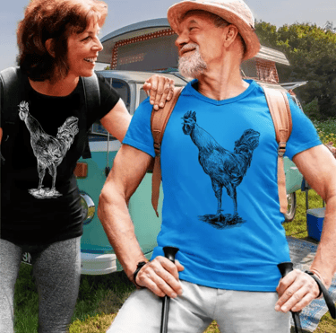 Smiling senior couple wearing rooster graphic trendyt-shirts while hiking near a vintage camper van.