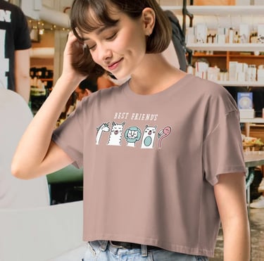 Woman wearing a dusty rose crop top t-shirt featuring a cute cartoon animal illustration.