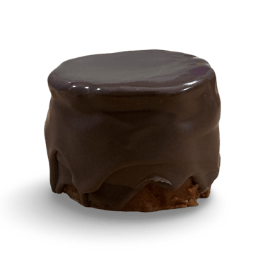 Small round chocolate ganache petit four cake with smooth dark icing on a black background.