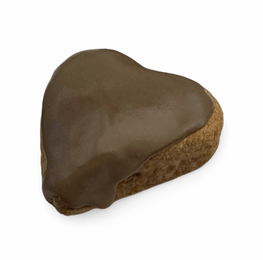 Heart-shaped gingerbread cookie topped with smooth chocolate icing against a black background.