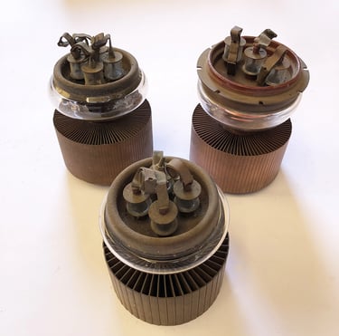 Three radio frequency transmitting vacuum tubes, aka: thermionic valves.