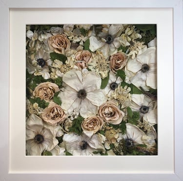 a white and peach flower wall style preserved wedding bouquet in a frame