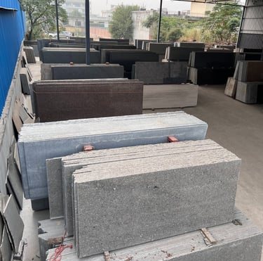 a pile of granite slabs in a gold stone granites mohali warehouse