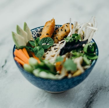 culinary tasty healthy bowl of food with coated fish fingers and fresh vegetables