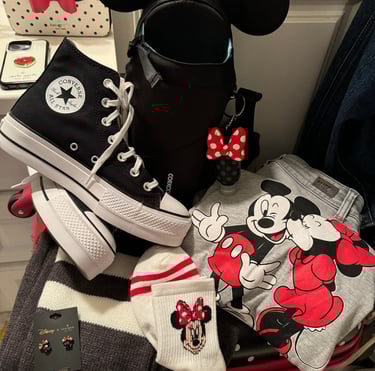 Adult Disney gear with backpack, Mickey and Minnie sweatshirt, and Minnie socks