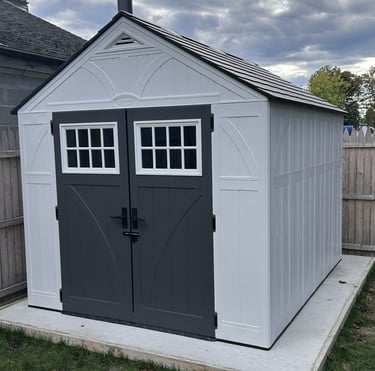 An assembled 8x10 Suncast Tremont resin shed from Home Depot - white plastic shed with dark grey doors