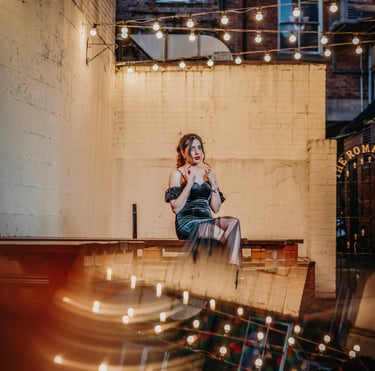 Bride posing under string lights in a York courtyard, captured by Fred Art Studio.