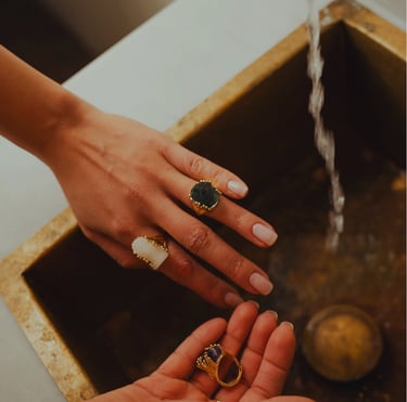 a woman's hands holding a ring with a ring on it