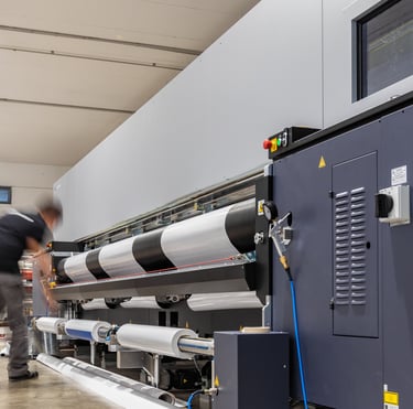 a man in a factory with a large machine