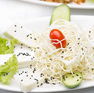 a plate of food with a tomato and cheese salad