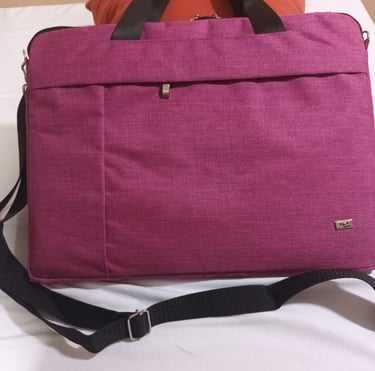 a laptop bag with a laptop on a bed