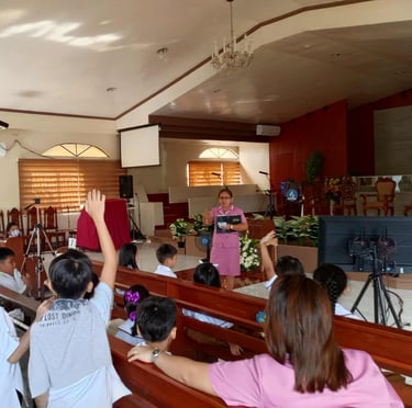 Elementary student raising his hand in a school chapel