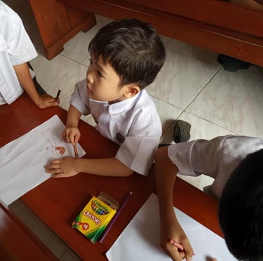 Elementary students coloring with crayons