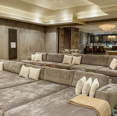 Plush tiered sectional seating with gray upholstery, and cup holders, designed for a luxury home theater by Solo Home Decor