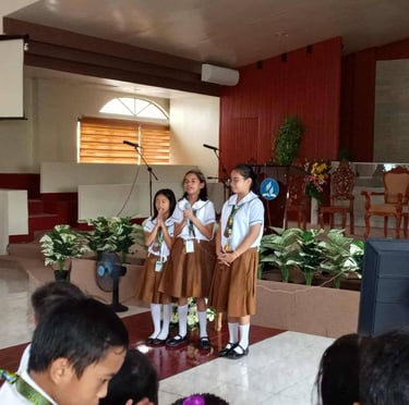 3 elementary girls praying in a school chapel