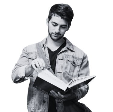A man reading a book he is holding open