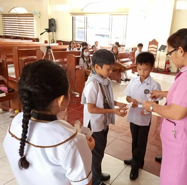 Elementary students presenting their paper letters to their teacher