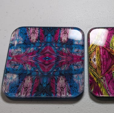 two square shaped coasters with a colorful pattern