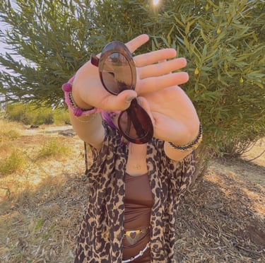 a woman in a leopard print jacket and sunglasses