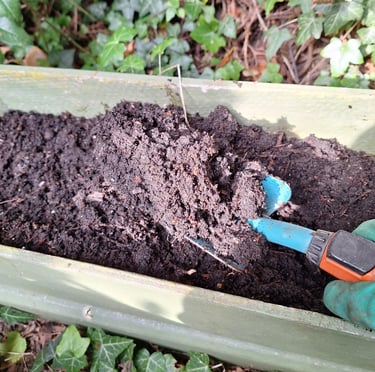 a person clearing the soil with a showel