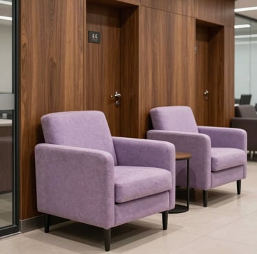 Photography of a stylish lounge area outside a corporate lactation room in a private firm in Hispanic / Corporate Latin America & Spain. Soft pastel lilac armchair, elegant corporate wood panels, tranquil atmosphere.