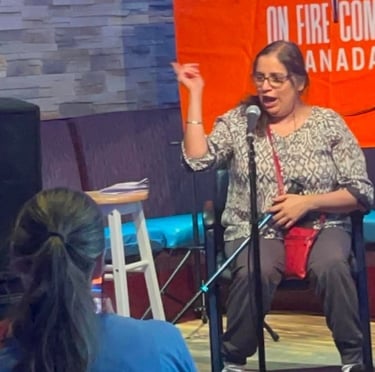 A female comedian performs a stand-up comedy set at On Fire Comedy Canada with a microphone.