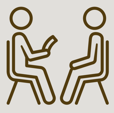 OT sitting with a patient and conducting an assessment