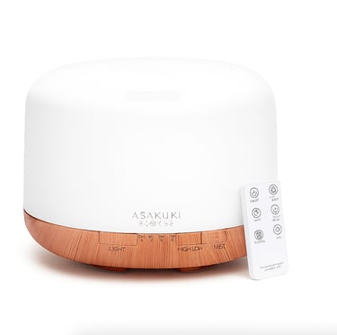 Essential oil diffuser with wood base and remote on white