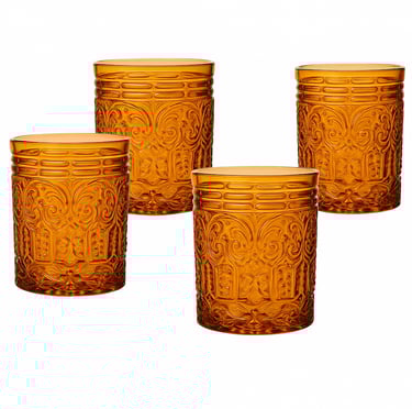 Four amber colored glasses with textured designs all over