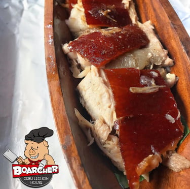 lechon slices on a wood plate
